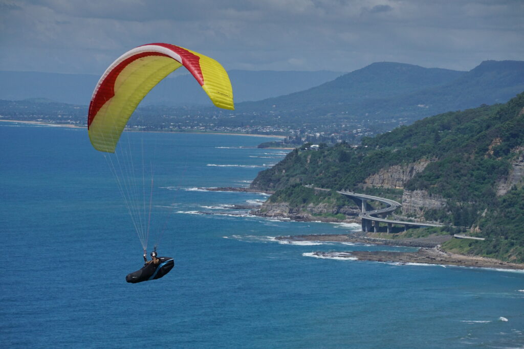 Hangglider in foreground, with Sea Cliff Bridge in background