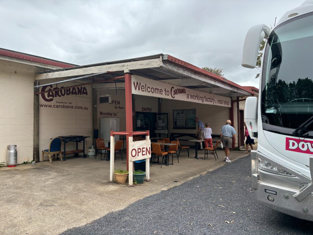 Front entrance to Carobana Carob Confectionery, with a tour bus partially in shot.