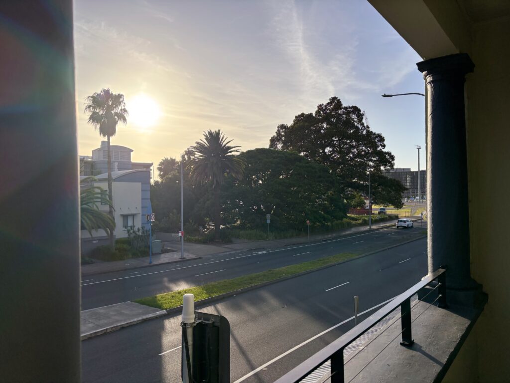 Picture of a low morning sun taken from a balcony.