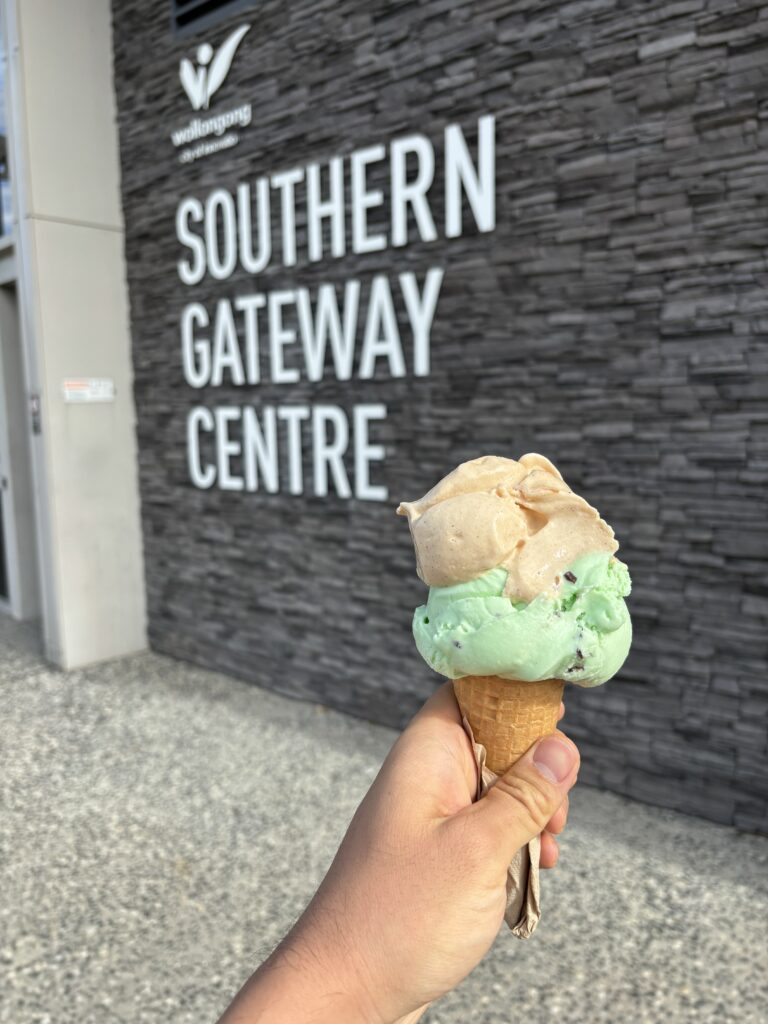 A large gelato on a cone, in front of a sign "Southern Gateway Centre".