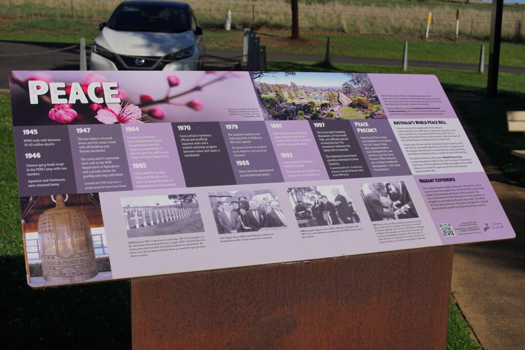 A large informational board with the title "Peace" and a timeline of events at the Prisoners of War Camp in Cowra, and later the Peace Precinct.