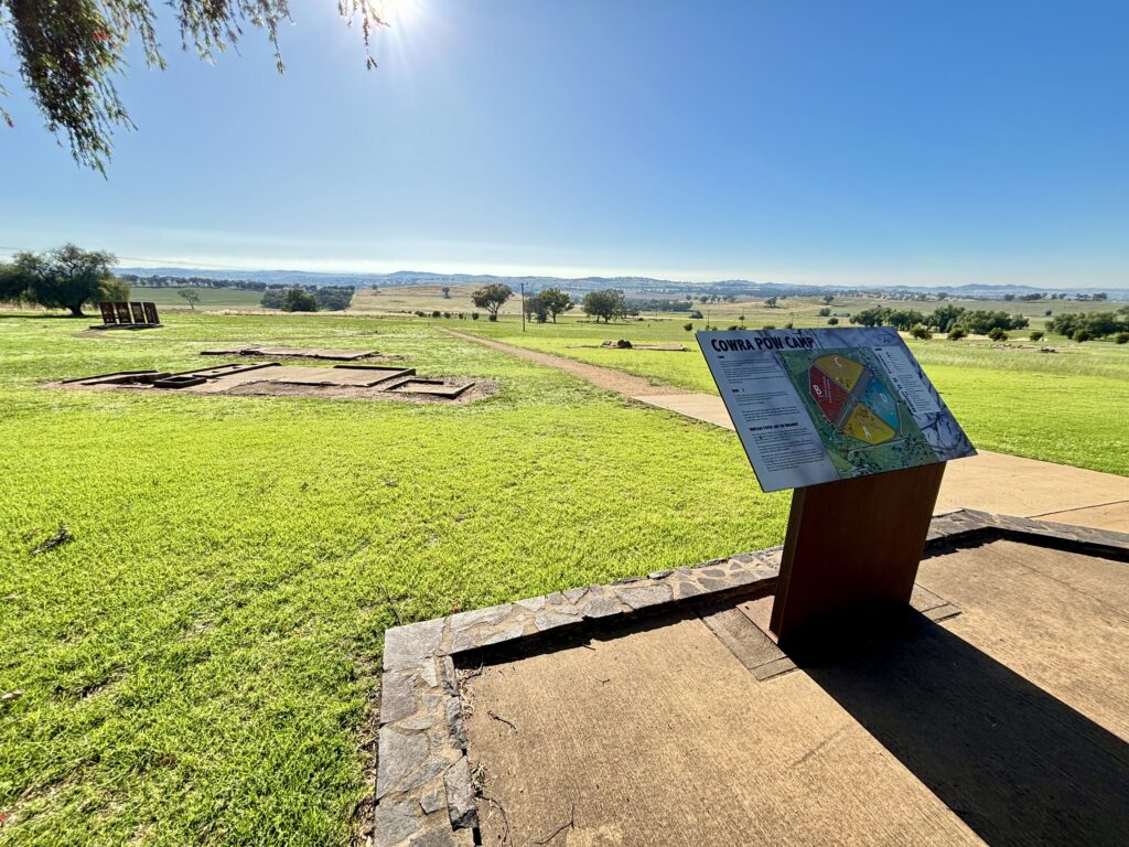 A wide shot over the former Cowra Prisoners of War Camp and the hillscape that surrounds it.