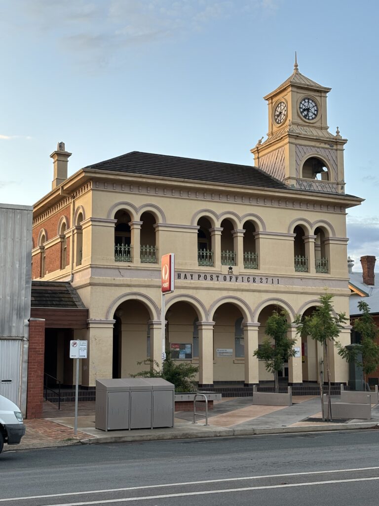 A building with a clock, with the sign "Hay Post Office 2711".