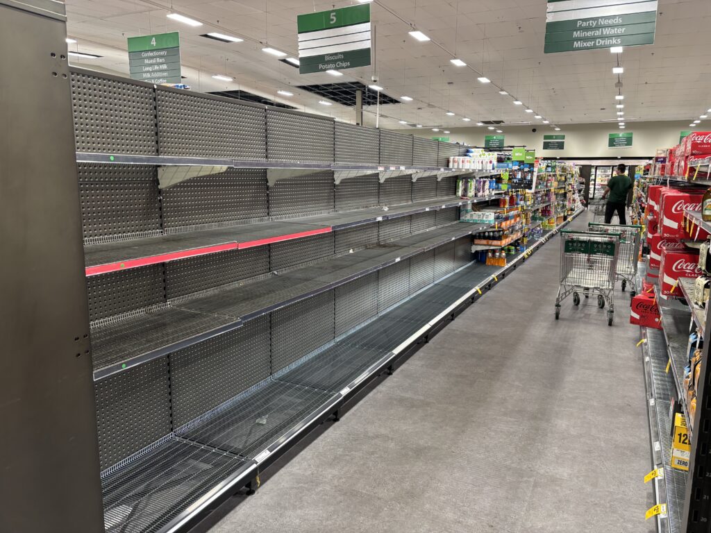 A supermarket aisle with all bottled water products gone.